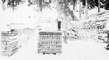 Three men in process of building a house by the park on Saunders Avenue, wpH121